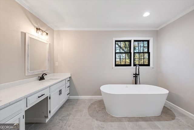 bathroom featuring vanity, ornamental molding, and a tub