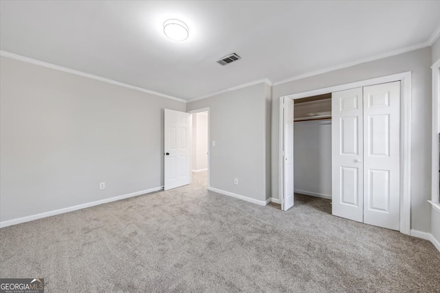 unfurnished bedroom featuring carpet flooring, a closet, and crown molding