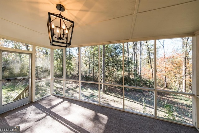 unfurnished sunroom featuring an inviting chandelier