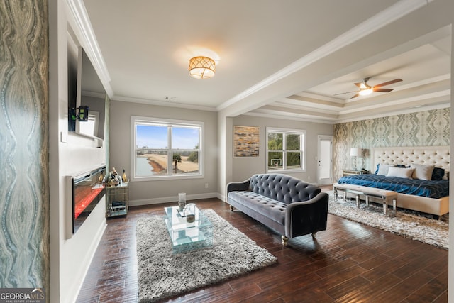 interior space featuring ceiling fan, plenty of natural light, crown molding, and dark hardwood / wood-style floors