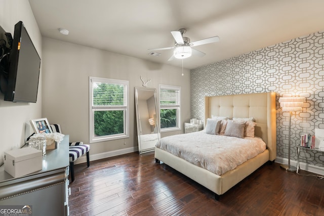 bedroom with ceiling fan and dark hardwood / wood-style flooring