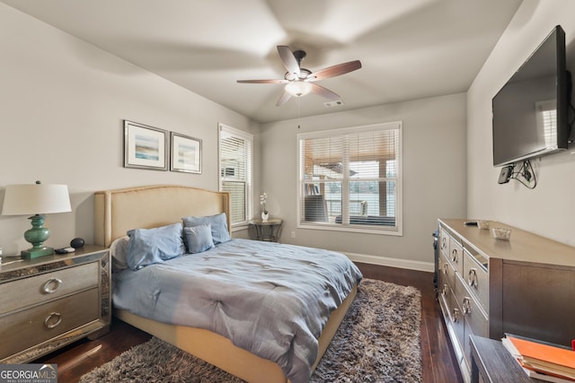 bedroom with ceiling fan and dark wood-type flooring