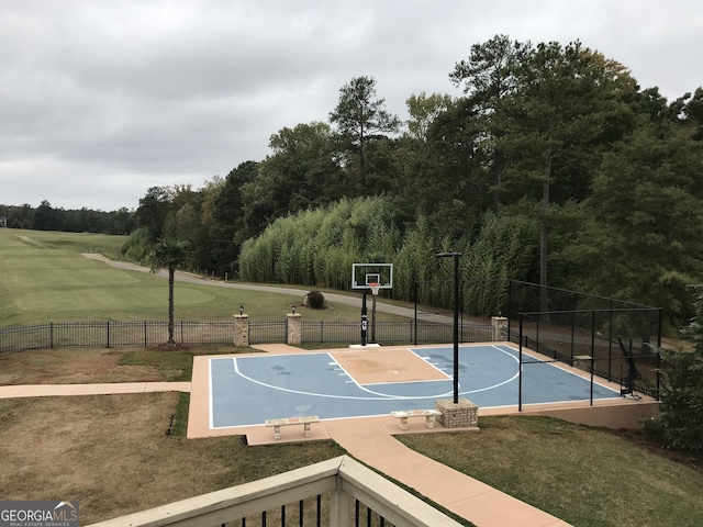 view of sport court featuring a yard