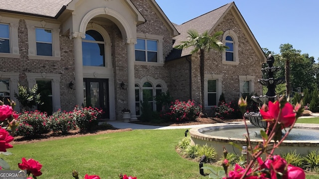 back of house with a lawn