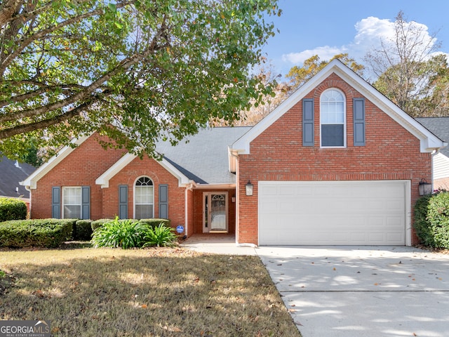 front facade featuring a front lawn and a garage