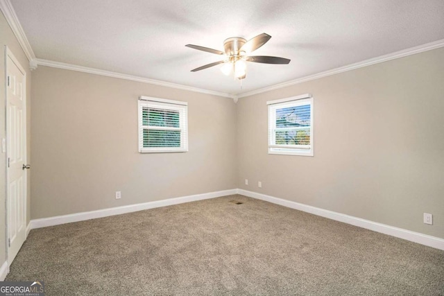 carpeted empty room with ceiling fan and ornamental molding