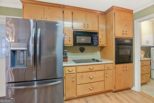 kitchen with ornamental molding, black appliances, and light wood-type flooring