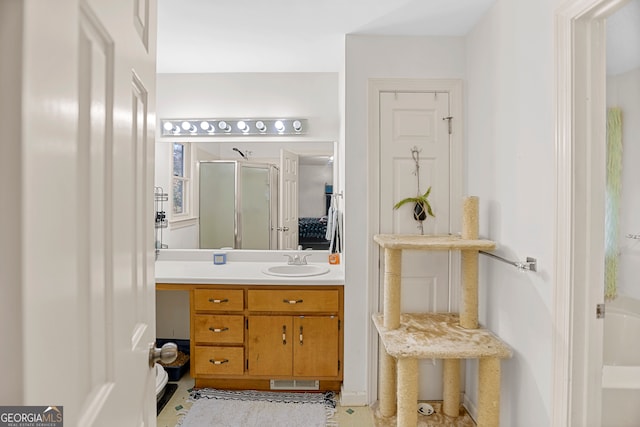 bathroom with tile patterned floors, vanity, and a shower with door