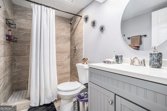 bathroom with vanity, toilet, and walk in shower