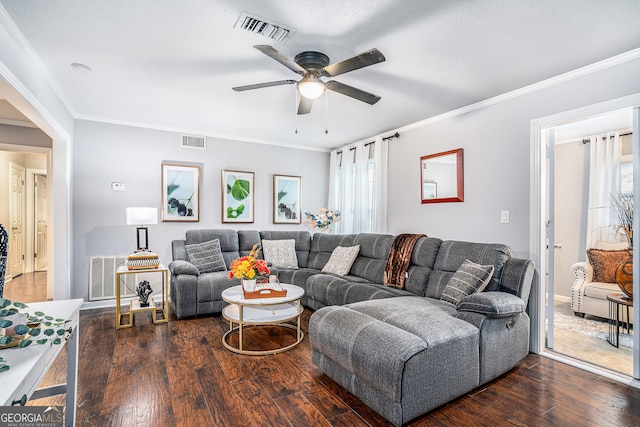 living room with dark hardwood / wood-style floors, ceiling fan, and ornamental molding