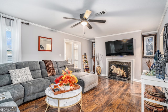 living room with ceiling fan, french doors, dark wood-type flooring, crown molding, and a fireplace