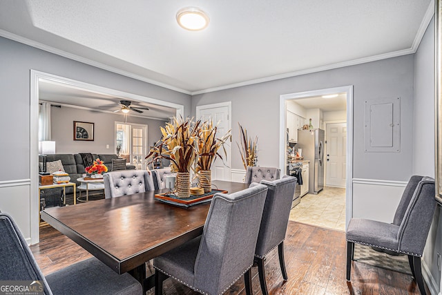 dining room with hardwood / wood-style floors, ceiling fan, and crown molding