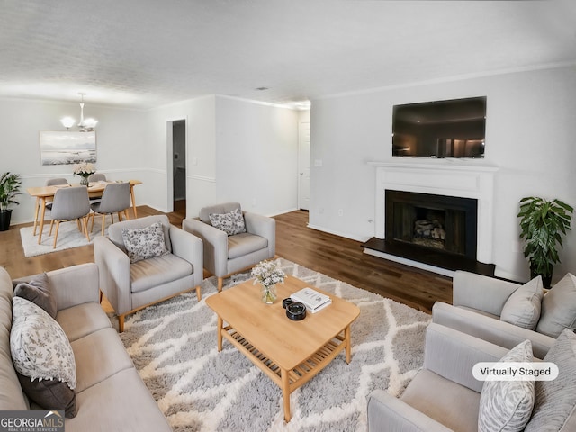 living room featuring a chandelier and wood-type flooring