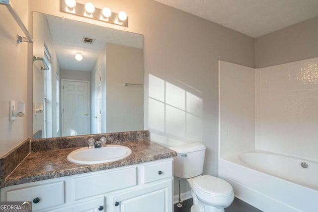 full bathroom featuring a textured ceiling, vanity, bathing tub / shower combination, and toilet