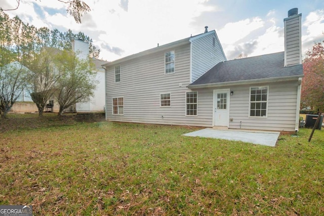 rear view of house featuring a patio area and a yard