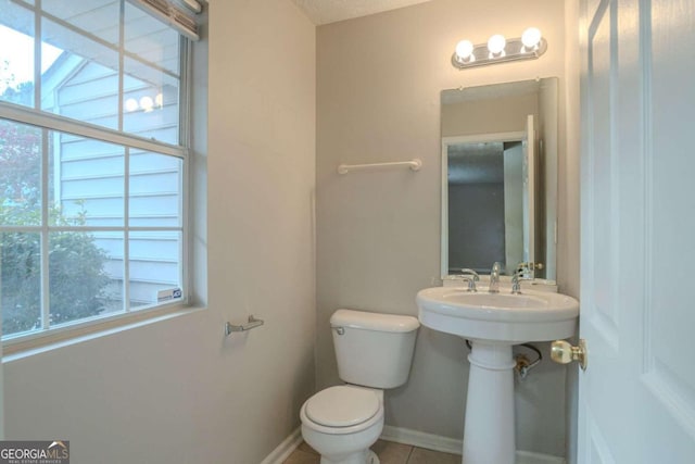 bathroom with tile patterned floors and toilet