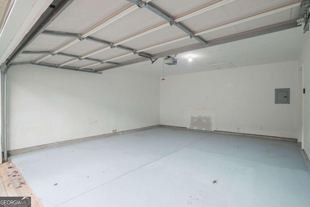 garage with a garage door opener and electric panel