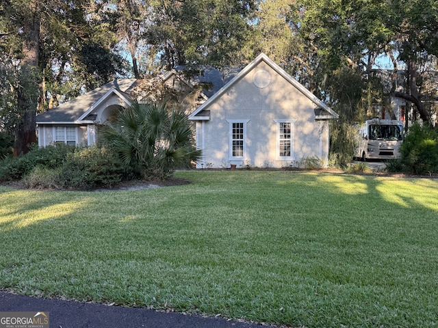 view of side of property with a yard