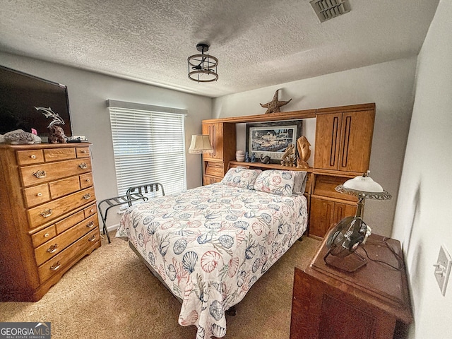 bedroom featuring a textured ceiling and dark colored carpet