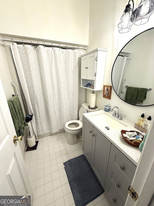 bathroom with tile patterned flooring, vanity, and toilet