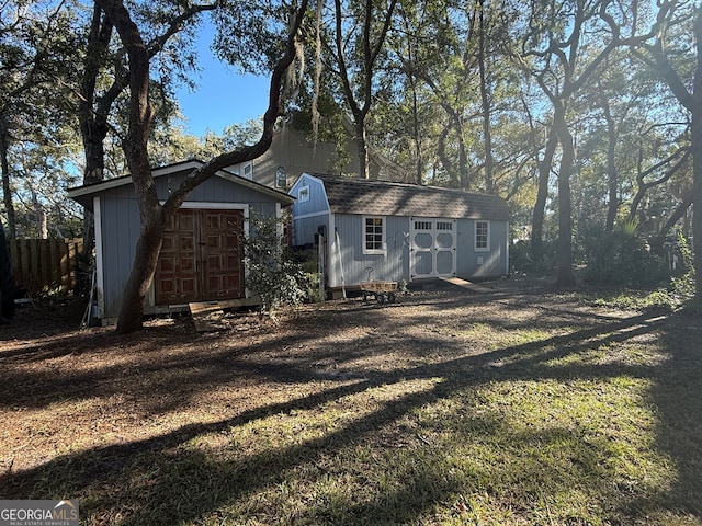 rear view of property featuring a shed