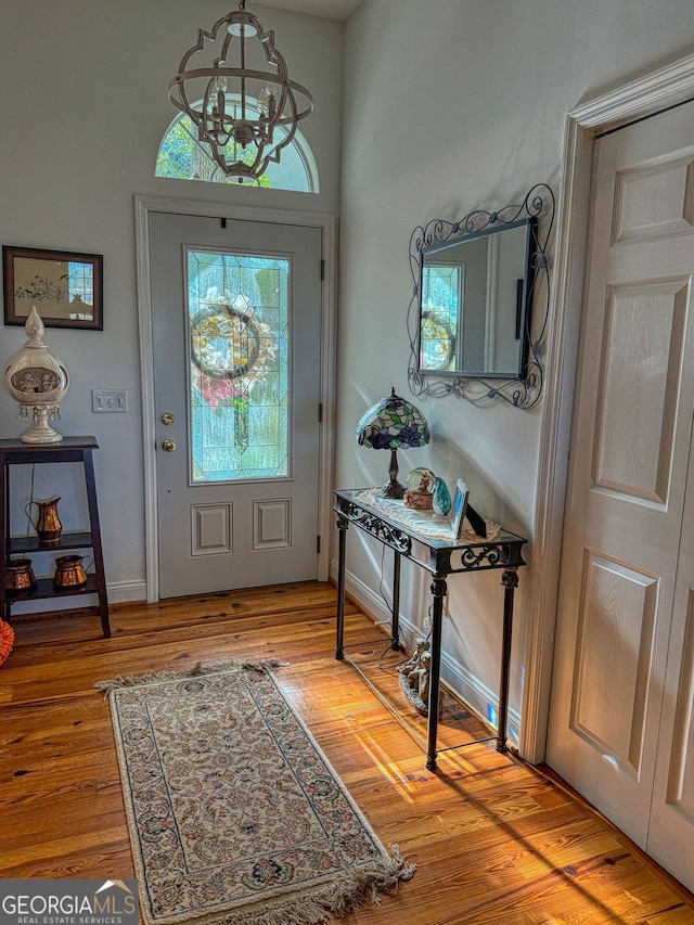 foyer entrance featuring an inviting chandelier and light hardwood / wood-style flooring