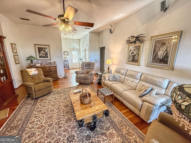 living room with dark hardwood / wood-style floors and ceiling fan