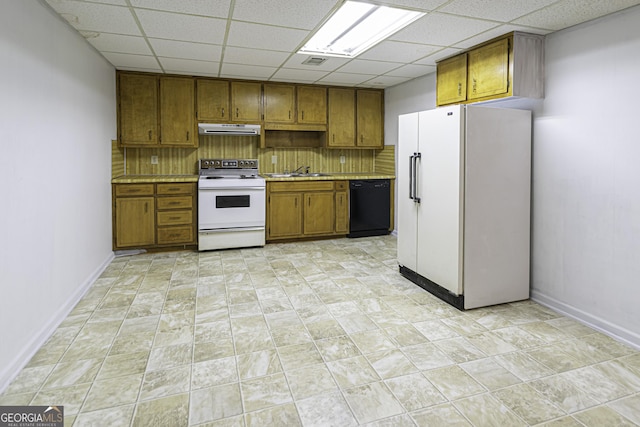 kitchen featuring a paneled ceiling, decorative backsplash, and white appliances