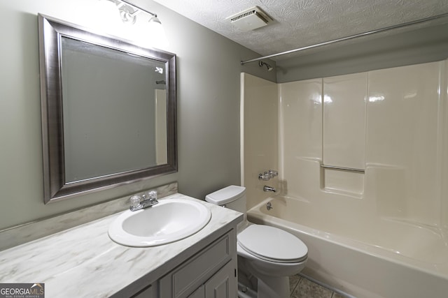 full bathroom with tile patterned floors, shower / bath combination, a textured ceiling, toilet, and vanity