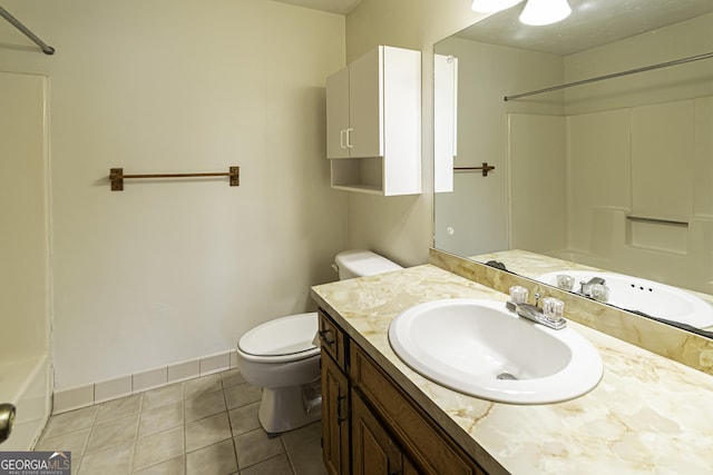 bathroom with toilet, vanity, and tile patterned floors