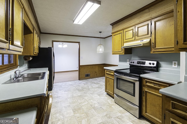 kitchen with pendant lighting, a textured ceiling, stainless steel appliances, and sink