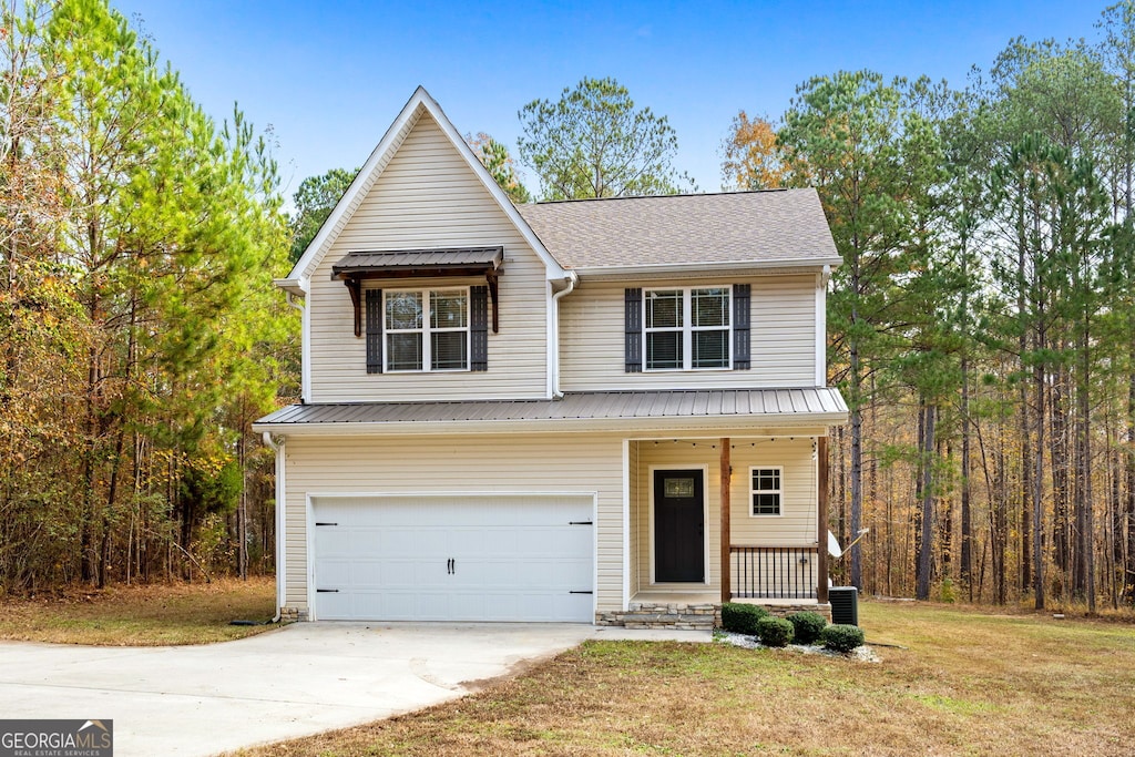 view of front facade featuring a garage, central AC, a front yard, and a porch