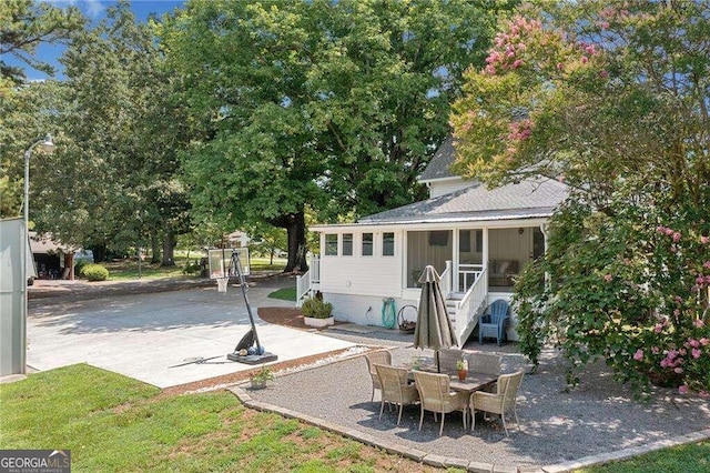 view of patio / terrace featuring a sunroom