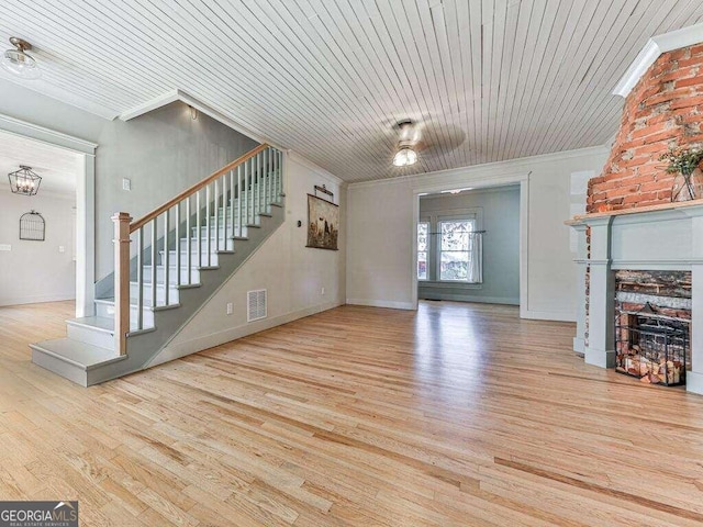 unfurnished living room featuring ceiling fan, wooden ceiling, and light wood-type flooring