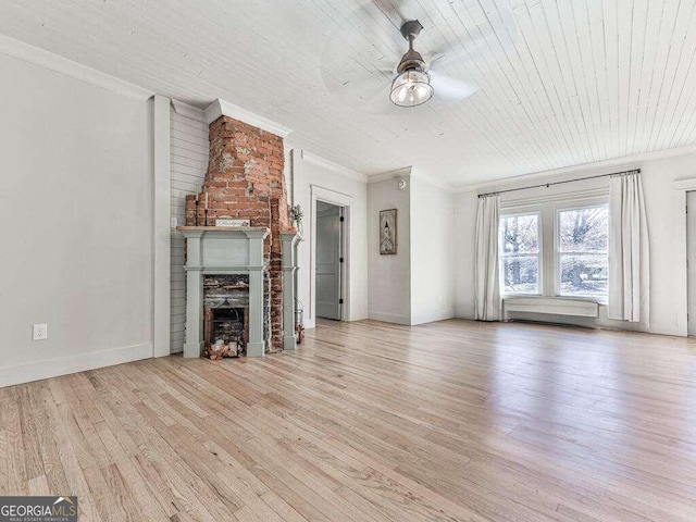 unfurnished living room featuring ceiling fan, a large fireplace, crown molding, wood ceiling, and light wood-type flooring