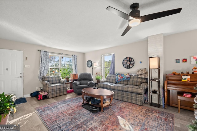 living room with wood-type flooring and ceiling fan