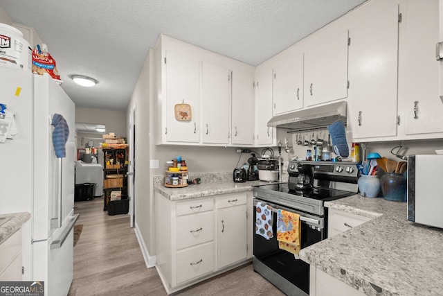 kitchen featuring electric stove, white cabinetry, white refrigerator, and a textured ceiling