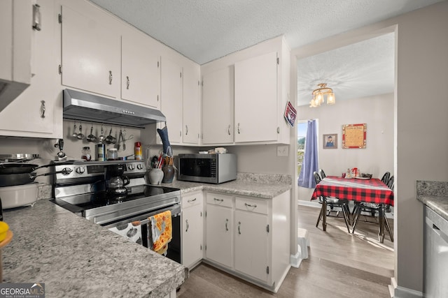 kitchen featuring stainless steel appliances, white cabinets, a textured ceiling, and light hardwood / wood-style floors