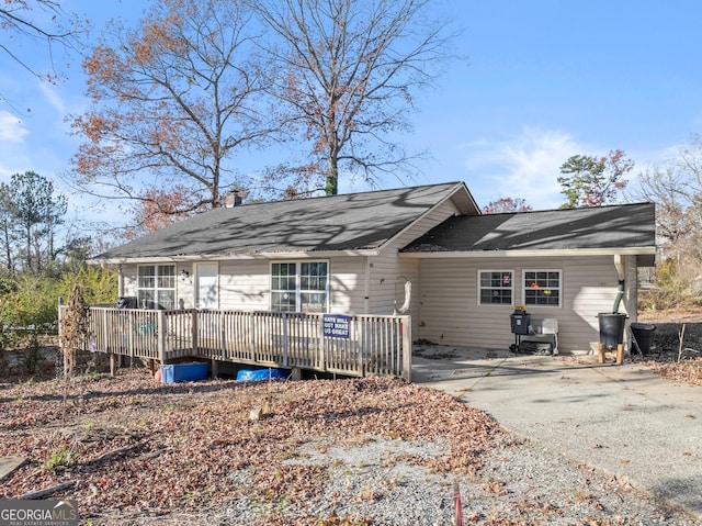 back of house with a deck