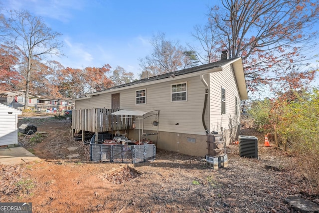 rear view of house with central AC