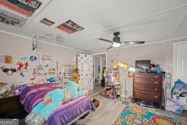 bedroom featuring crown molding, ceiling fan, and light hardwood / wood-style flooring