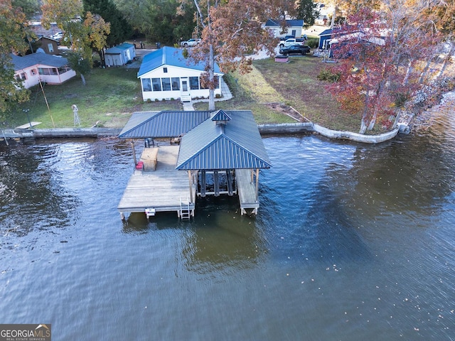 dock area with a water view and a lawn