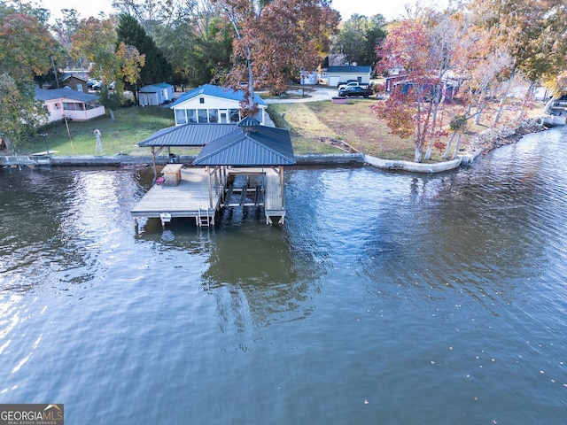 view of dock featuring a water view and a lawn