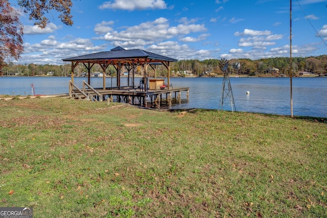 dock area featuring a water view and a lawn