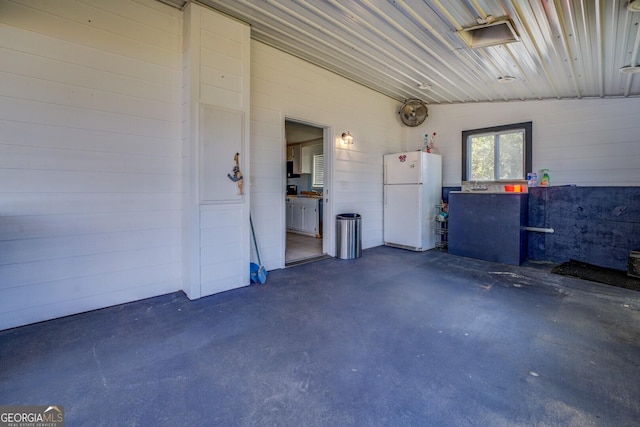 garage with white fridge