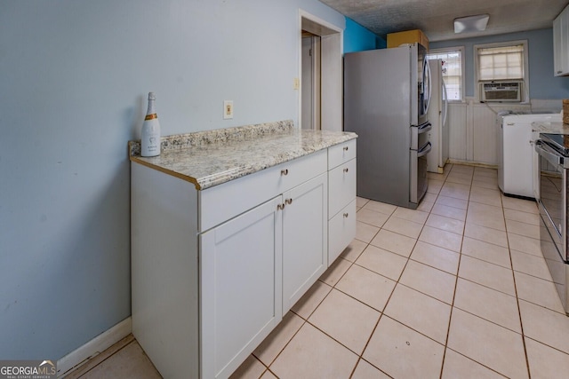 kitchen featuring light tile patterned floors, appliances with stainless steel finishes, cooling unit, light stone counters, and white cabinets