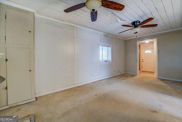 unfurnished room featuring ornamental molding, light colored carpet, ceiling fan, and wood ceiling