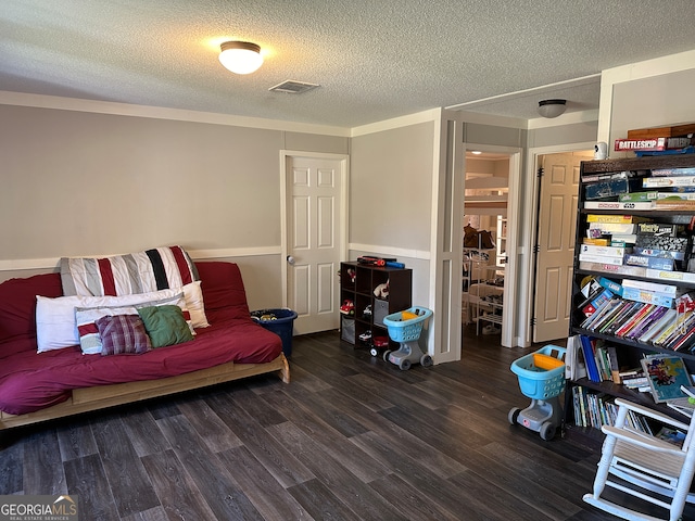 sitting room with dark hardwood / wood-style flooring and a textured ceiling