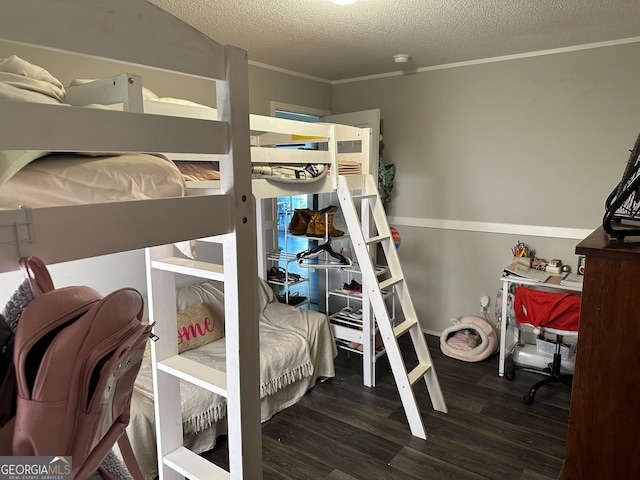 bedroom featuring dark hardwood / wood-style flooring, ornamental molding, and a textured ceiling