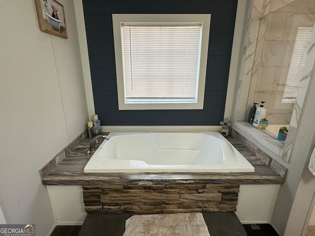 bathroom featuring a tub to relax in